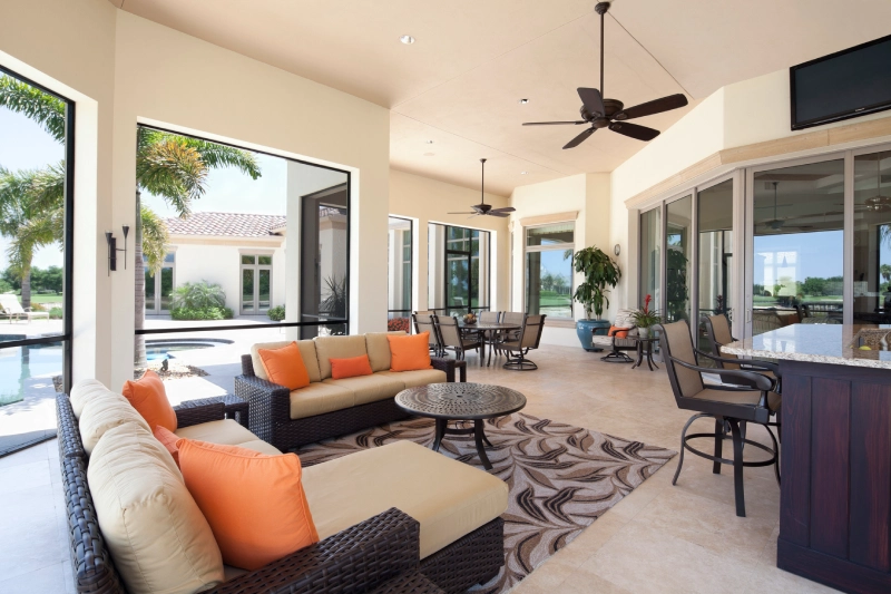 Spacious outdoor patio with modern furniture and ceiling fan.