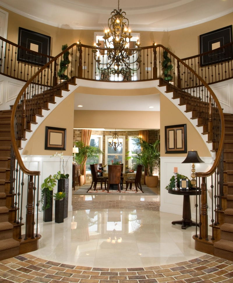 Elegant double staircase in a luxurious home entrance.