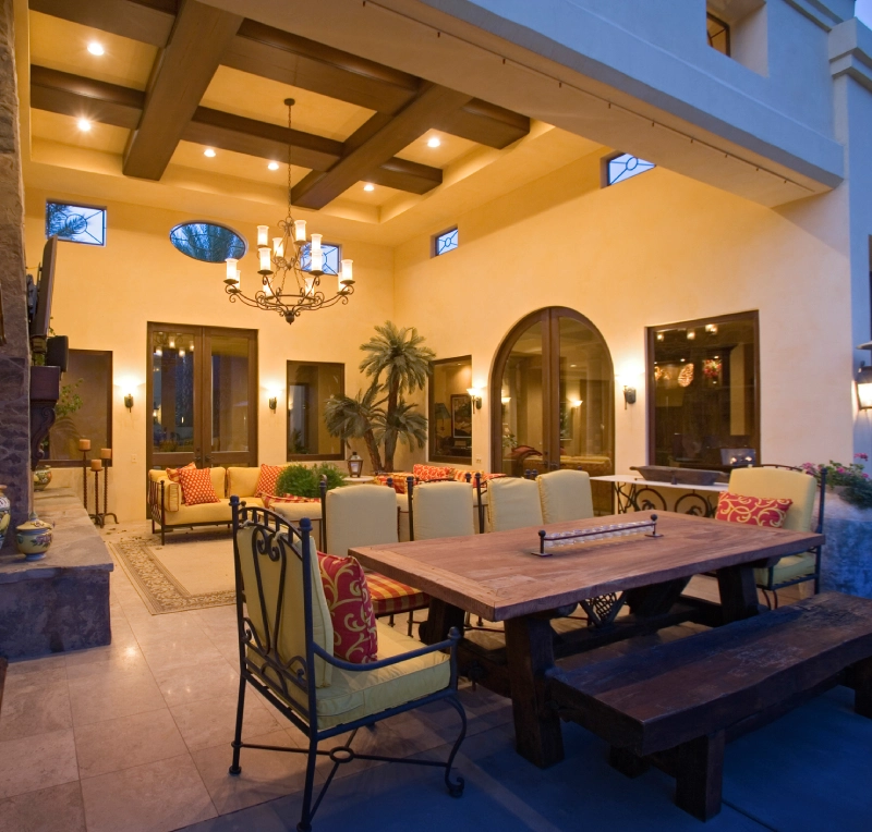 Cozy outdoor patio with warm lighting and rustic decor.