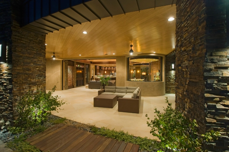 Elegant outdoor lounge area with modern furniture and warm lighting.